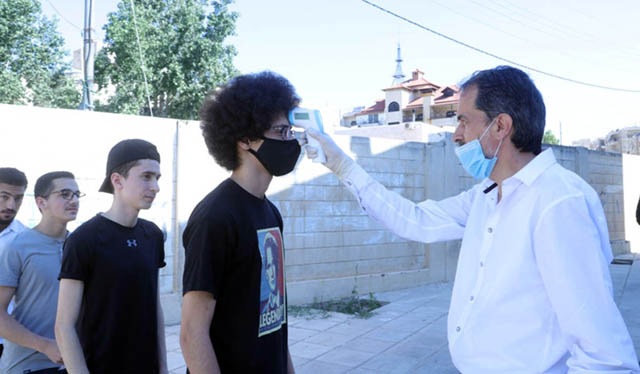Students' temperatures are checked before they are allowed to enter Tawjihi halls (Petra photo)